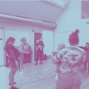 Mødre står i rundkreds med børn og synger